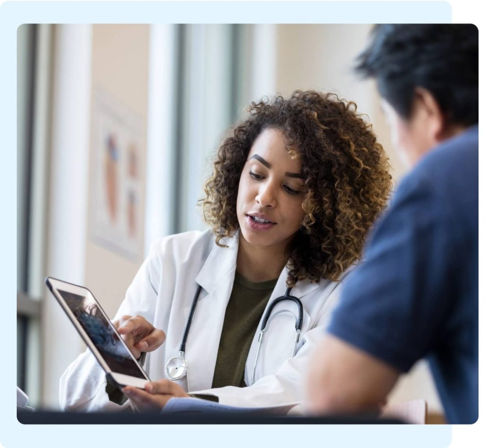 Doctor uses a tablet during a consultation about mesothelioma diagnosis